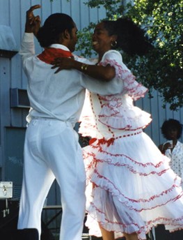 1998 photo of Neri Torres dancing with man during a performance by Cuban dance and music ensemble