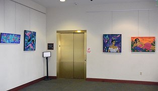 Photo of elevator doors with art work on the walls on either side