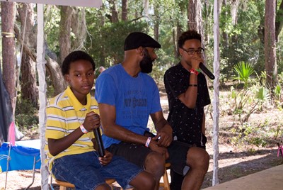 Photo of Jamal Jones teaching young kids freestyle rhyme at the Florida Folk Fest