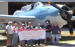 Photo of a group of veterans in front of a World War Two era airplane